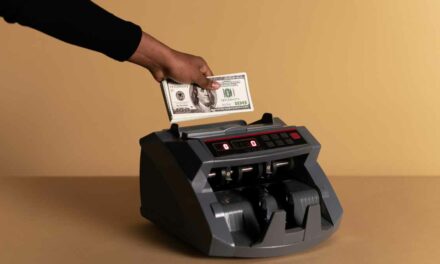 six-figure success for creators vusualized by a money counting machine counting 100 dollar bills